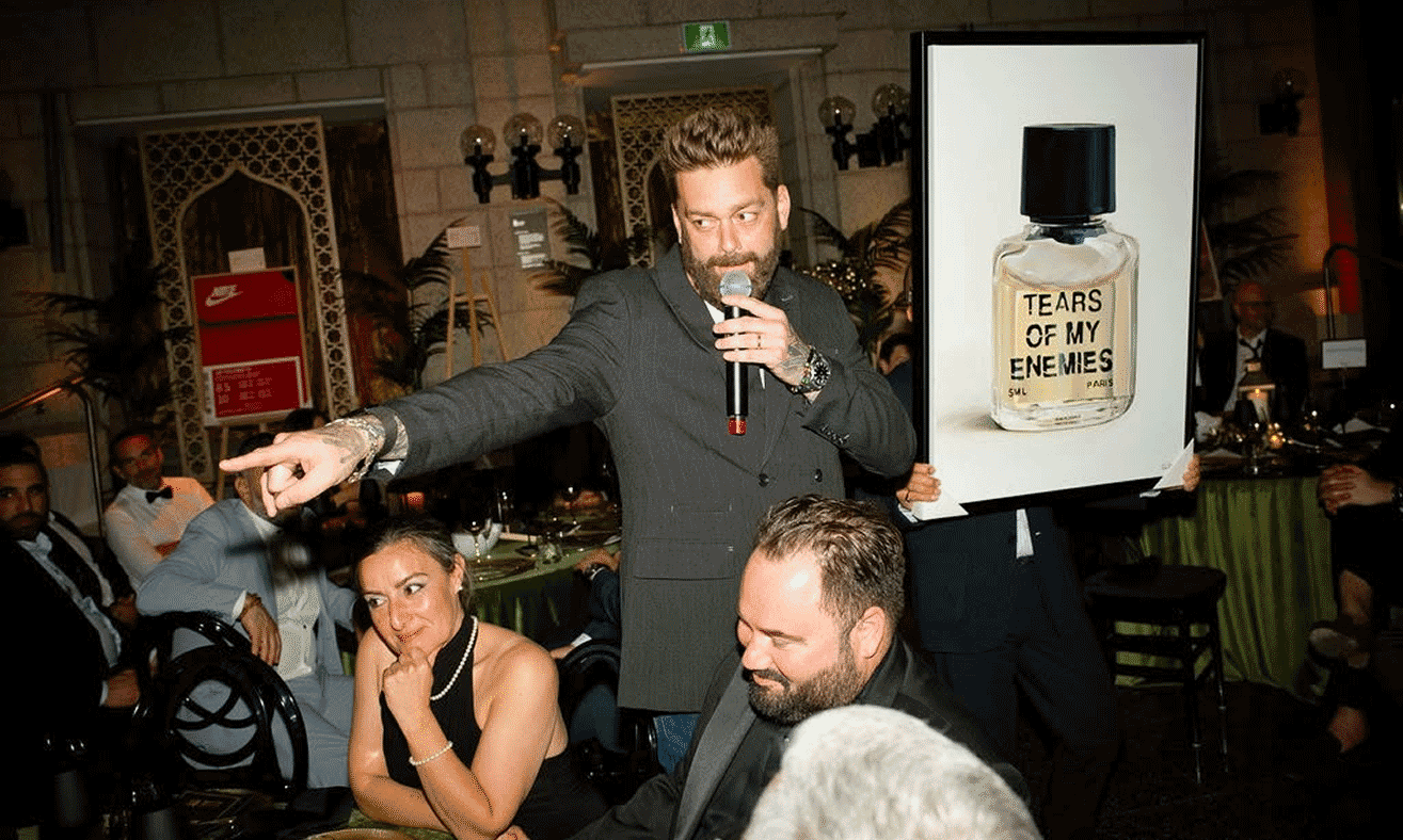 Auction host presenting artwork to guests